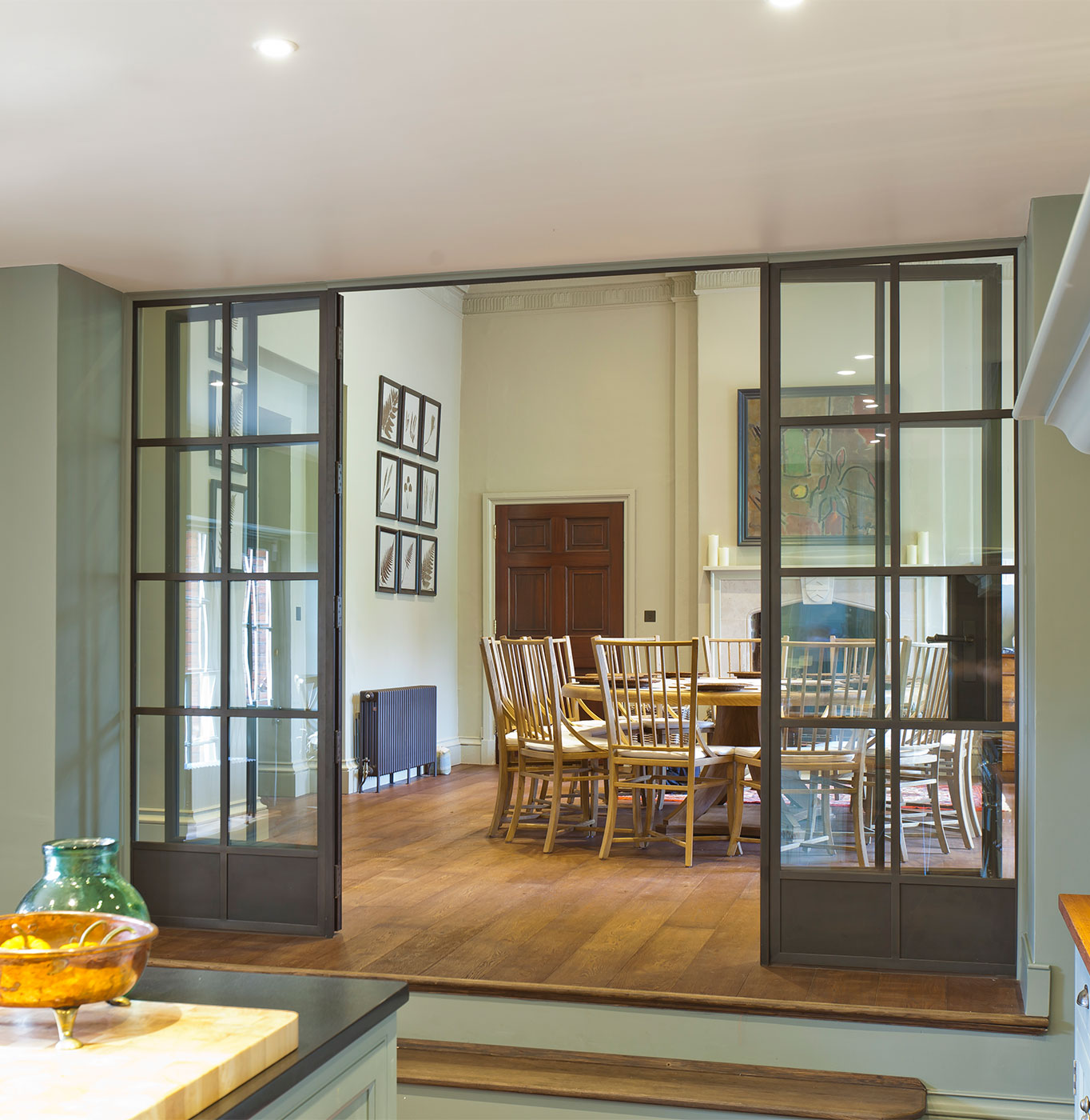 Glass room divider between kitchen and dining room