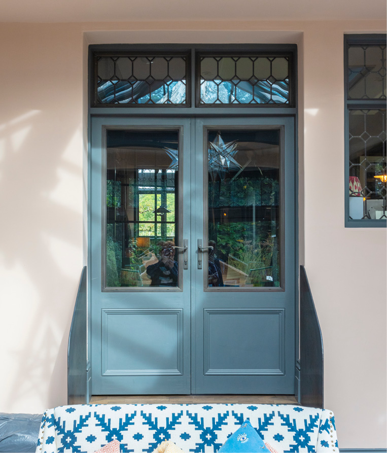 coloured timber door with bronze insert