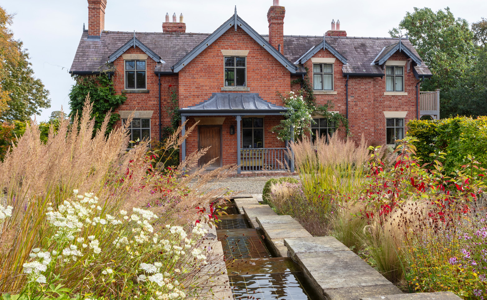 decorative garden desgn leading to farmhouse